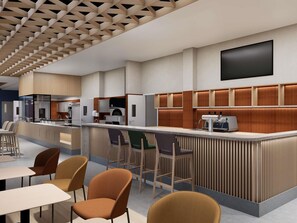 A modern kitchen with built-in appliances and a bar area with seating. - Ibis Almaty East (Opening Autum 2026) (Almaty)
