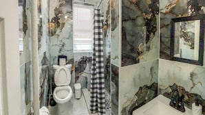 A bathroom with a toilet, bidet, and sink. - 20 Mins to Manhattan w/Full kitchen (Apt. 5) (West New York)