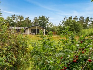 A modern house with a large window and a patio. - "Söffren" - 450m to the fjord by Interhome (Øster Assels)