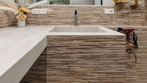 A modern bathroom with a rectangular sink, a mirror, and a wall-mounted towel rack. - Vrbo Property (Uhldingen-Mühlhofen)