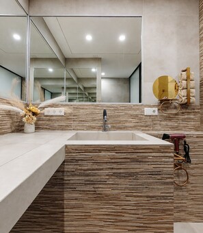 A modern bathroom with a rectangular sink, a mirror, and a wall-mounted towel rack. - Vrbo Property (Uhldingen-Mühlhofen)