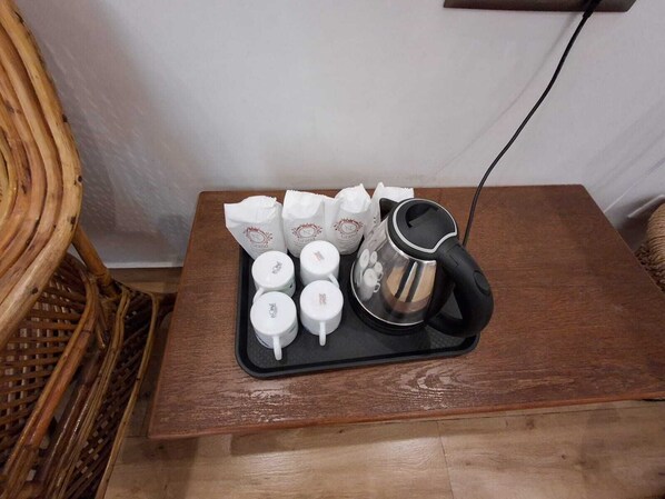 A tray with a coffee maker and several white cups on a wooden table. - NT Grand Inn (Yercaud)
