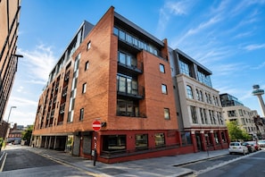 A multi-story building with a brick facade, large windows, and a no entry sign. - Inclusive 1BR Central Abode w Parking and Balcony (Liverpool)