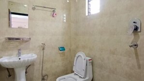 A bathroom with a pedestal sink, toilet, and a small window. - Hotel Forestway Hostel and Backpackers (Pokhara)