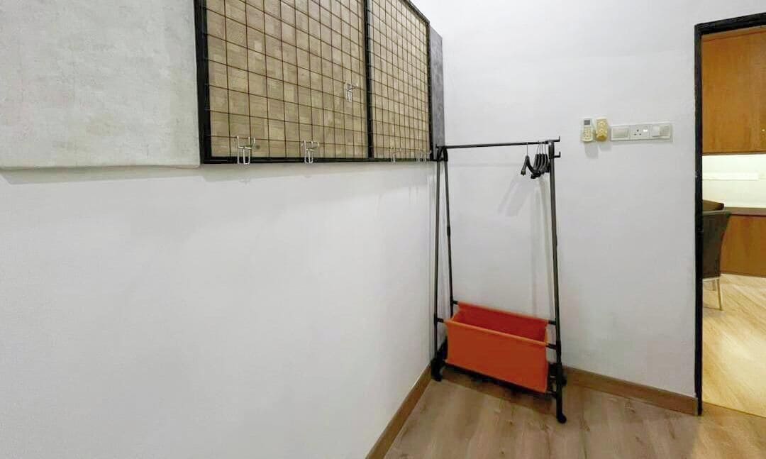 A room with a wooden floor, a window with a grid pattern, a door, and a red storage unit.