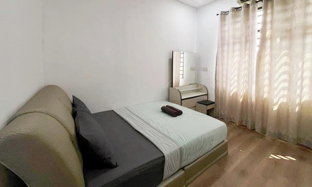 Quarto com cama, escrivaninha, cadeira, espelho e janela com cortinas.
