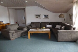 A living room with a sofa set, a coffee table, and a lamp. - Holiday apartment with 1 bedroom (Sonthofen)