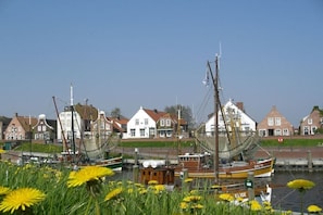 A harbor with traditional houses and boats. - Holiday home with 2 bedrooms (Krummhörn)