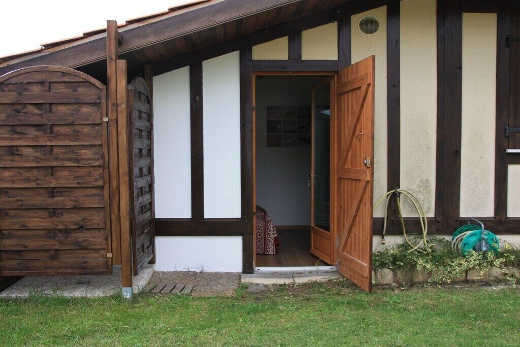 A traditional building with a wooden door and a small porch area.