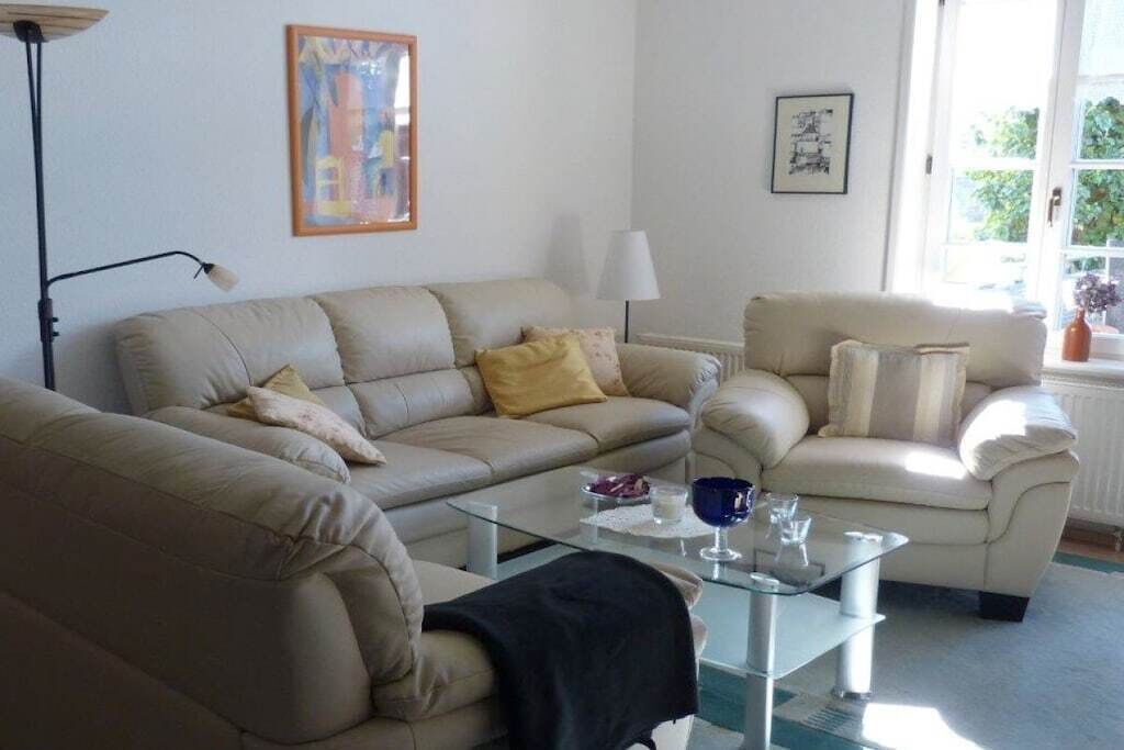 A living room with two sofas, a coffee table, and a lamp.