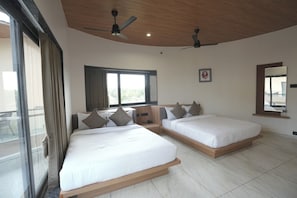 A hotel room with two beds, a ceiling fan, a window with curtains, and a balcony view. - Cloud9 Club Resort (A Unit of Dawon Hospitality) (Sasan Gir)
