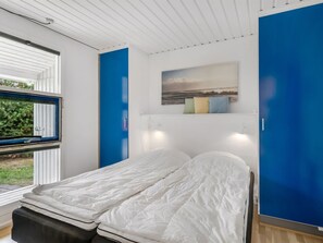 A modern bedroom with a bed, a window, and a painting on the wall. - "Jale" - 300m from the sea by Interhome (Thisted)