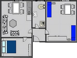 A hotel room layout with a bed, seating area, and a bathroom.