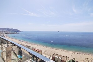 A coastal cityscape with a beach, buildings, and a clear sky. - SUNSET SAILORS elegant apartment (Benidorm)