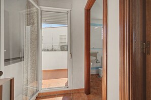 A bathroom with a sink, toilet, and shower area.