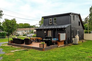 A two-story house with a patio area featuring outdoor furniture and a grill. - Lantz Retreat  Hot Tub • Spacious Deck (Lebanon)