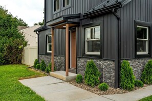 A modern two-story house with a stone foundation and a dark exterior. - Lantz Retreat  Hot Tub • Spacious Deck (Lebanon)