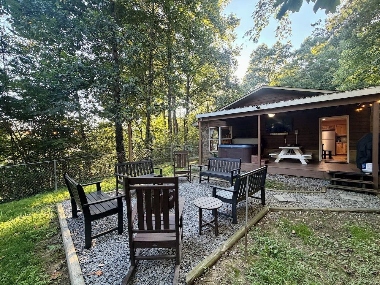 A patio area with outdoor seating and a covered structure with a barbecue.