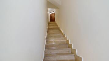 Una scala con ringhiera che porta a un pianerottolo.