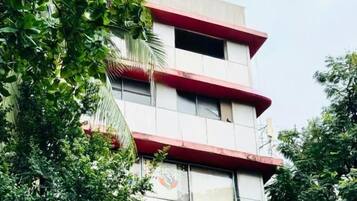 Un immeuble hôtelier à plusieurs étages, doté de balcons et d’une enseigne indiquant qu’il s’agit de l’« hôtel Comfort Castle ».