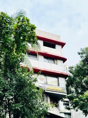 A multi-story hotel building with balconies and a sign indicating it is the 'Hotel Comfort Castle.' - Hotel Comfort Castle (Mumbai)