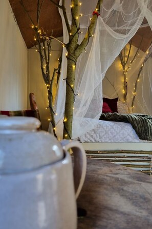 A room with a bed, a decorative tree with lights, and a white canopy. - Camping Ont Moeten - T piept zo by Interhome (Rekken)