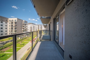 A balcony with a clear view of a residential area, including multi-story buildings and a green space. - Kierbedzia Beige Elagant, Mokotow, Warsaw (Warszawa)