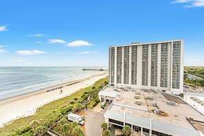 A high-rise hotel with a beach view, a parking area, and a dock. - S Hampton 1206 3 Br Oceanview in Kingston, Pool (Myrtle Beach)