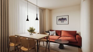 A modern living room with a wooden dining table, chairs, a red sofa, and a coffee table. There is a framed picture on the wall and a vase with flowers on the table. - Bob W Athens Stadiou (Athens)