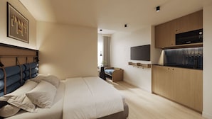 A modern bedroom with a bed, bedside tables, a TV mounted on the wall, and a wooden cabinet with a built-in microwave.