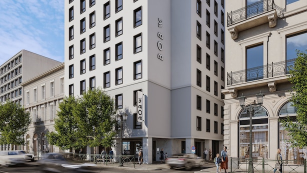 A multi-story hotel with a modern facade, large windows, and a prominent 'BOB W.' sign.
