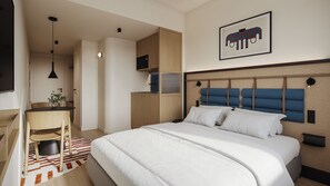 Habitación de hotel moderna con cama, escritorio, silla y una pequeña kitchenette.