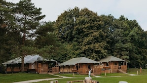 A campsite with yurts, a picnic table, and a fire pit. - De Glamping - Trio Lodge | 18p by Interhome (Zeewolde)