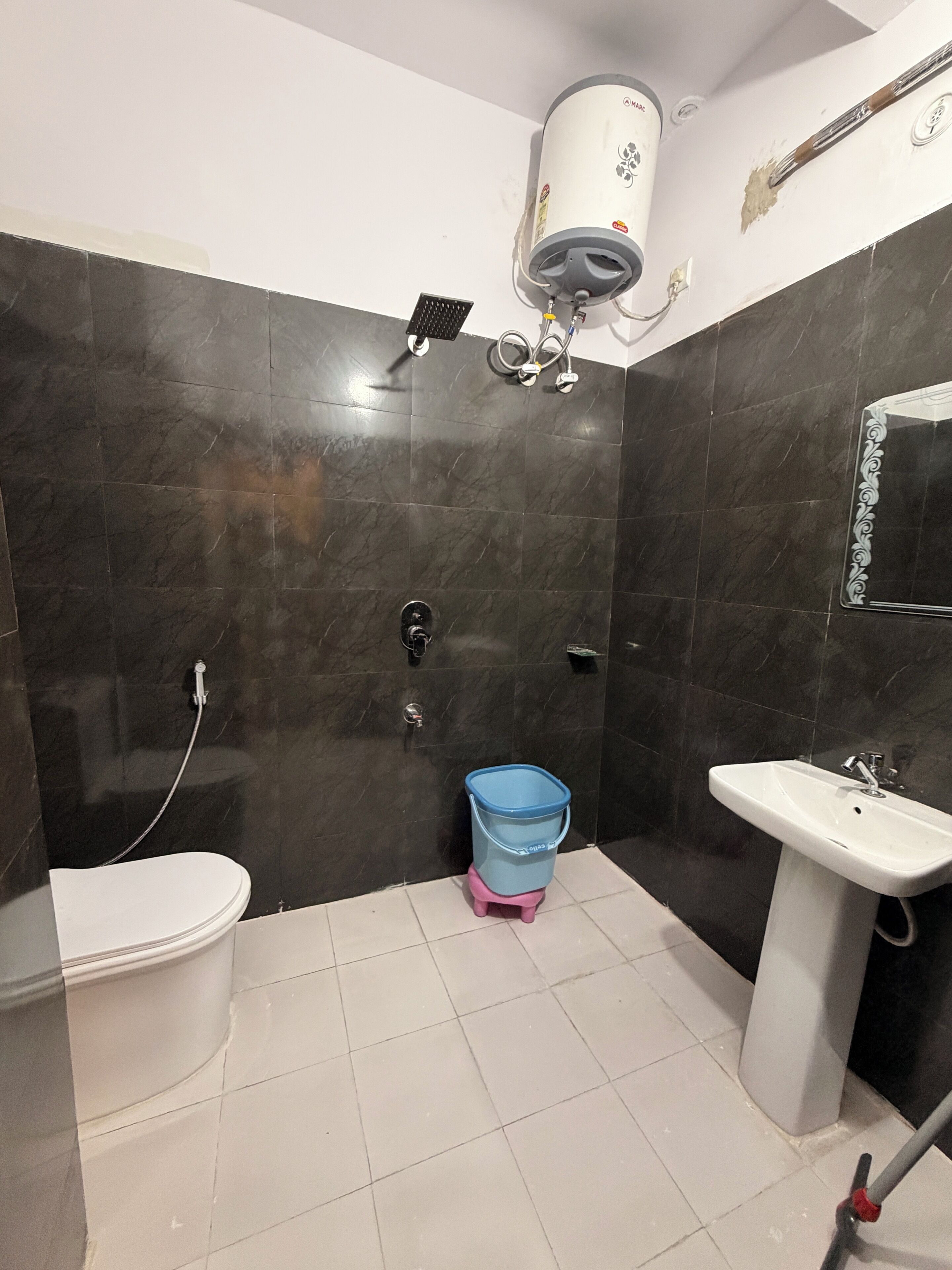 Een badkamer met toilet, wastafel en douche.