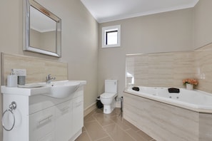 A bathroom with a sink, toilet, and bathtub.