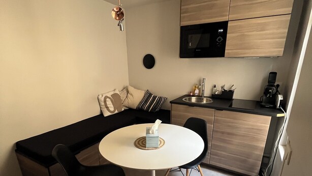 A compact kitchen with a microwave, coffee maker, and a small sink. - Charming house in the city center (Angoulême)