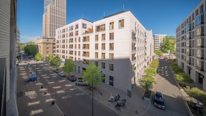 A multi-story building with a modern architectural design, featuring a mix of balconies and large windows. - Apartment Krochmalna 61 (Warszawa)