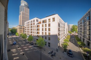 A multi-story building with a modern architectural design, featuring a mix of balconies and large windows. - Apartment Krochmalna 61 (Warszawa)