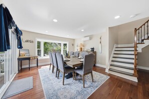 A dining area with a table, chairs, and a view of the outdoors. - Lakefront Retreat | Game Room • Pizza Oven (Hewitt)