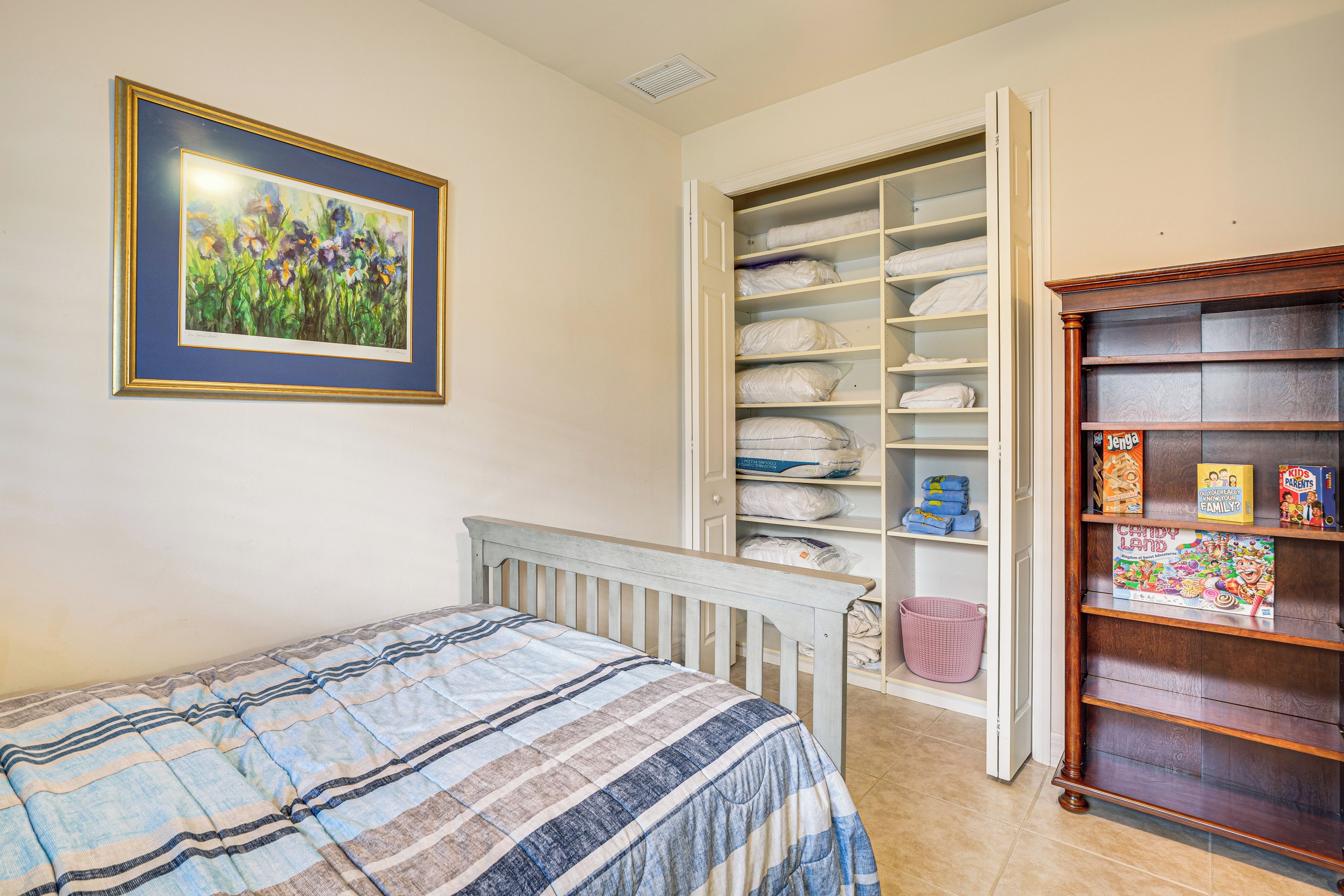 A bedroom with a bed, a wardrobe, and a bookshelf.