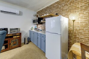 A compact kitchen with a refrigerator, microwave, and toaster. - Easy Raleigh Access! Quaint Apt w/ Patio (Garner)