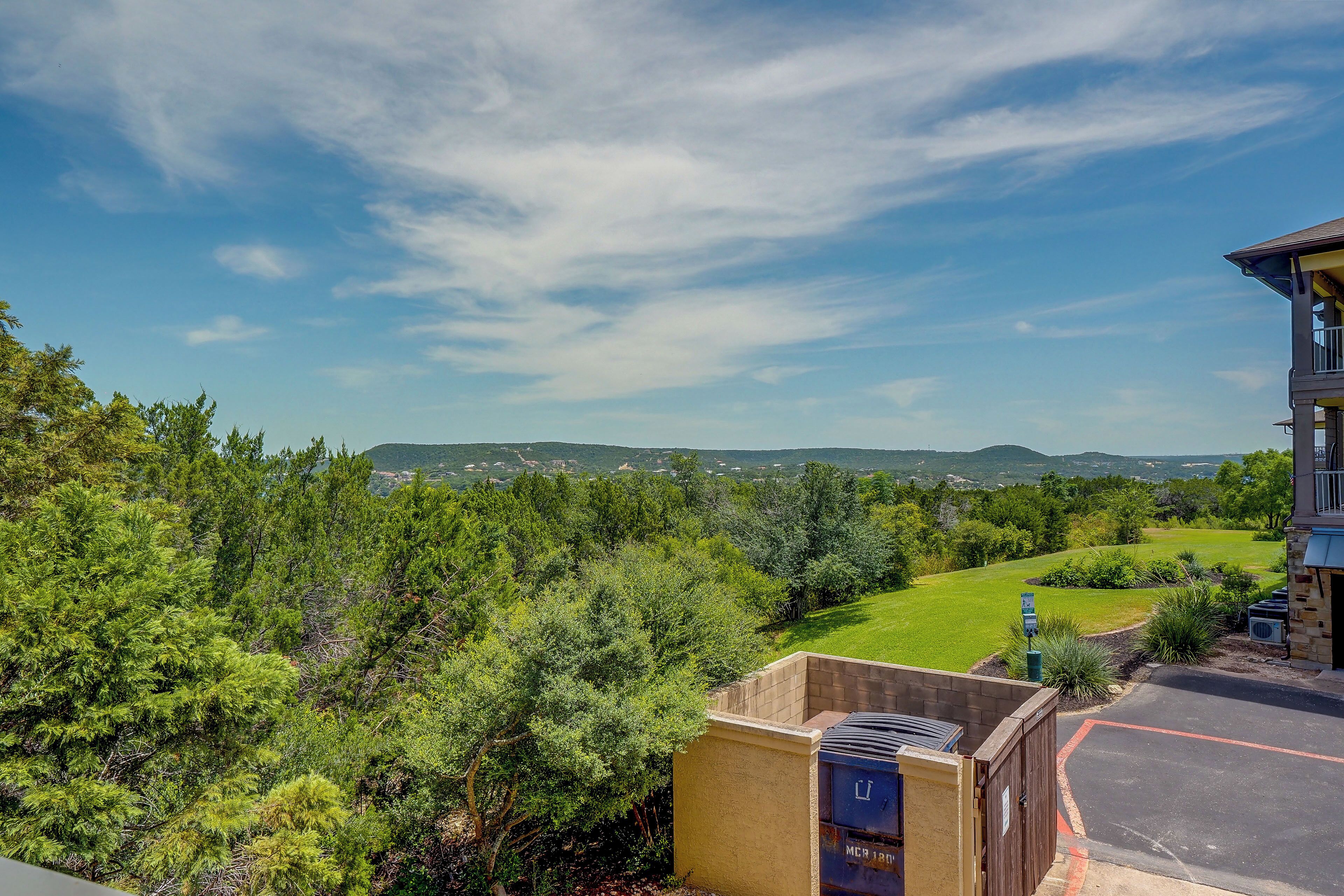 Zona residencial com vista para uma paisagem verde e colinas ao longe.