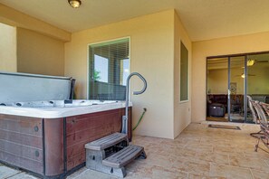 A hot tub with steps, a hose, and a window with blinds. - Las Cruces Oasis: Patio, Hot Tub + Mtn Views (Las Cruces)