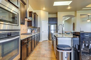 A modern kitchen with stainless steel appliances, a granite countertop, and a built-in oven. - Las Cruces Oasis: Patio, Hot Tub + Mtn Views (Las Cruces)