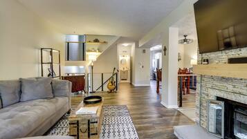 A living room with a sofa, coffee table, and fireplace.