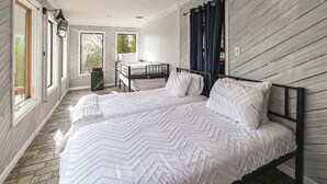 A bedroom with a large bed, a desk, and a window with curtains. - Group Getaway w/ Lake Views in Bronston! (Bronston)