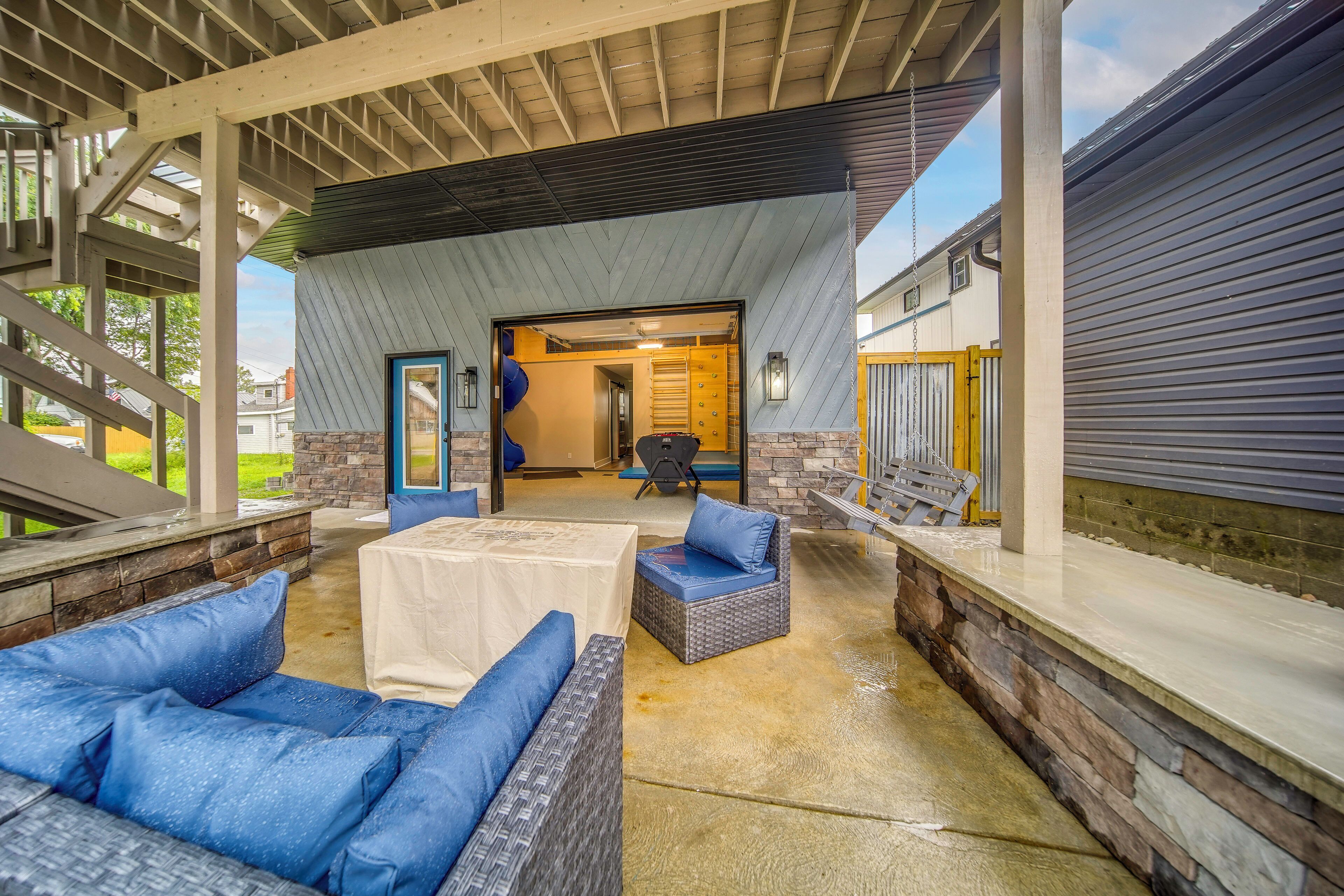 An outdoor covered patio area with seating and a view into the house.