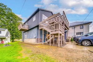 A two-story house with a balcony and a garage. - Family Fun! Indoor Jungle Gym, Hot Tub & Beach (Erie)