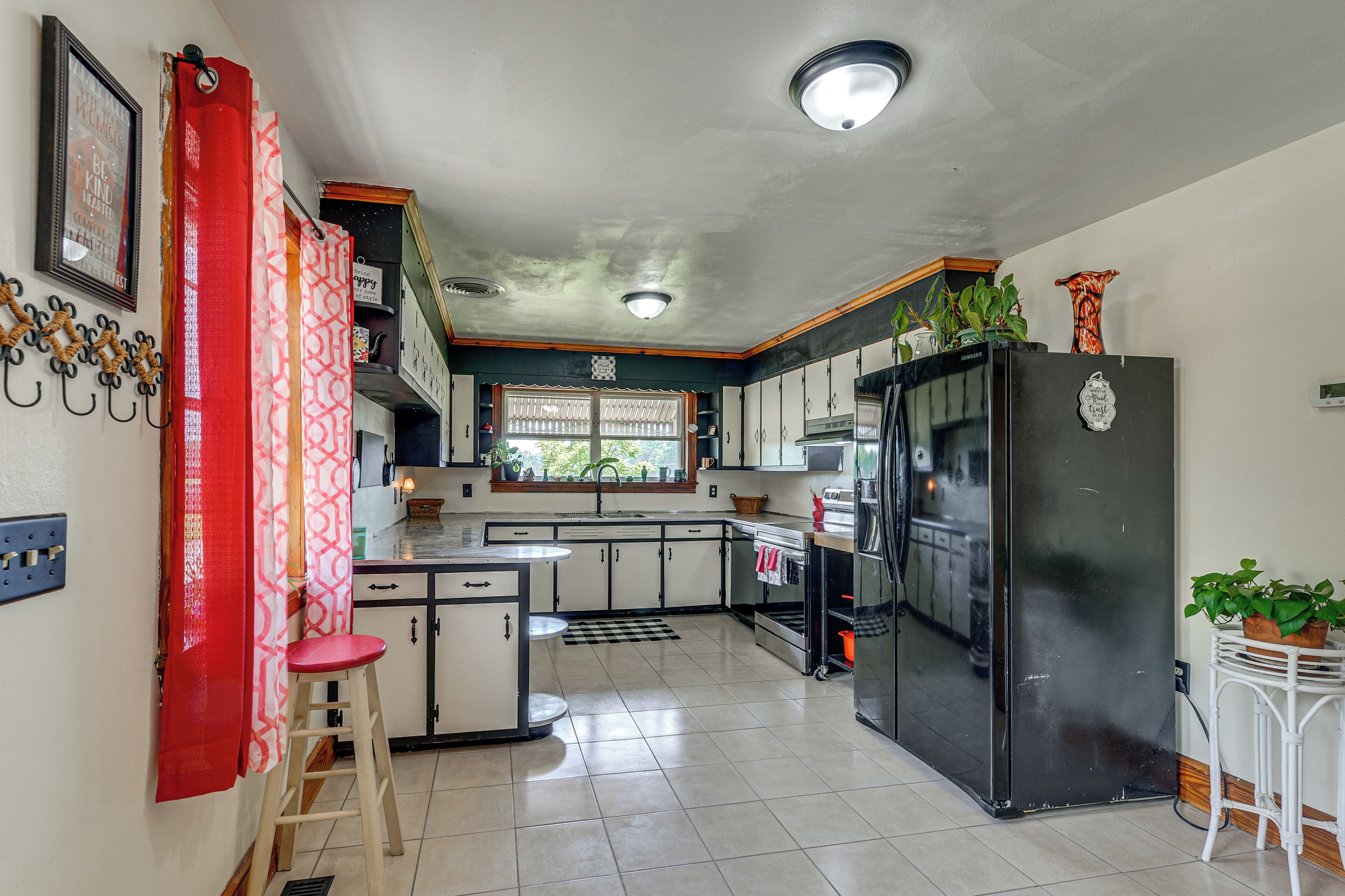 A kitchen with a refrigerator, stove, and sink.