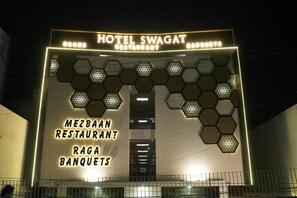 A building with a sign for Hotel Swagat, Mezzanine Restaurant, and Raga Banquets.